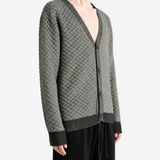 Grey knitwear worn by a person, showing the knitwear fit