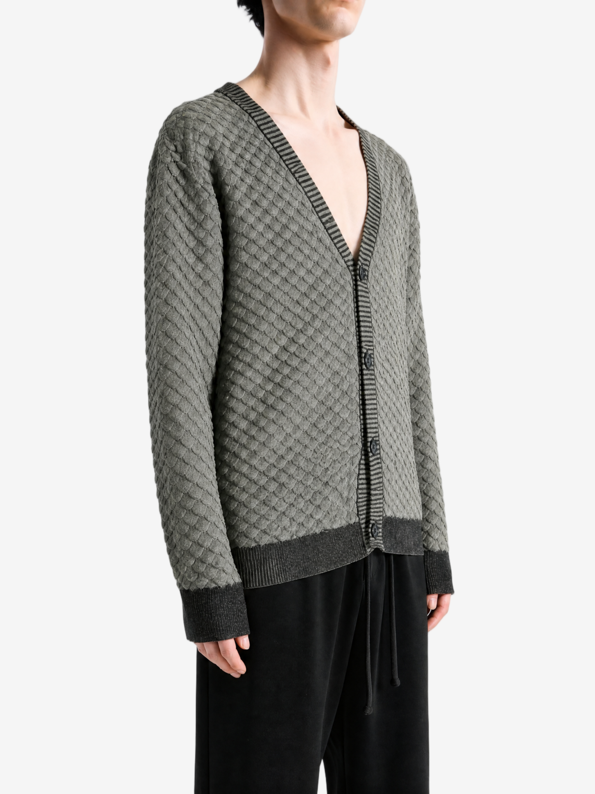 Grey knitwear worn by a person, showing the knitwear fit