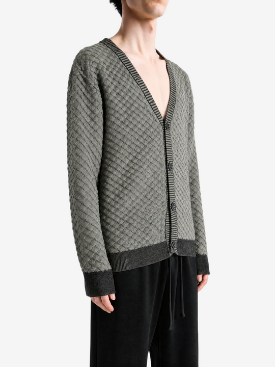 Grey knitwear worn by a person, showing the knitwear fit