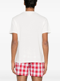 White t-shirt worn by a person, showing the shirt's fit