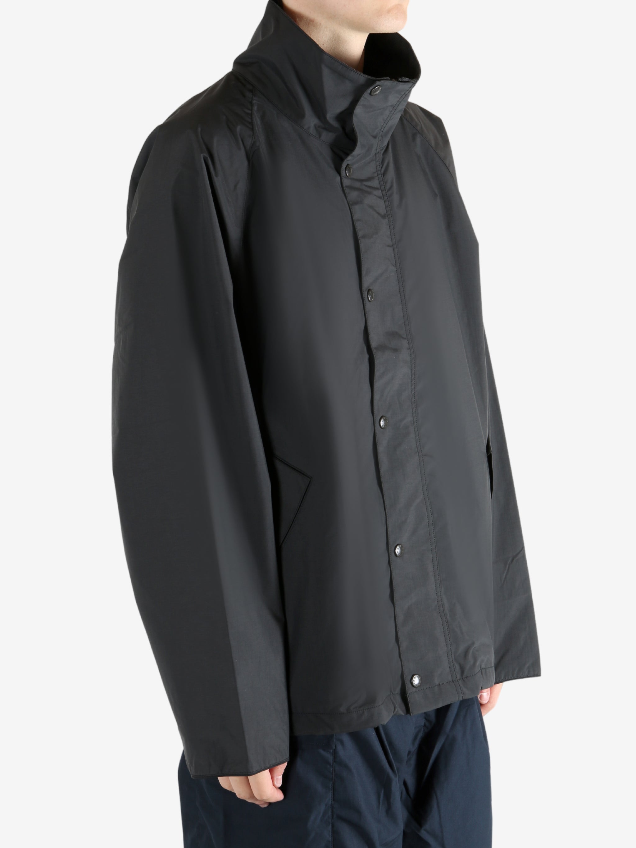 Black jacket worn by a person, showing the jacket's fit