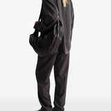 brown bag worn by a person, showing the bag's fit