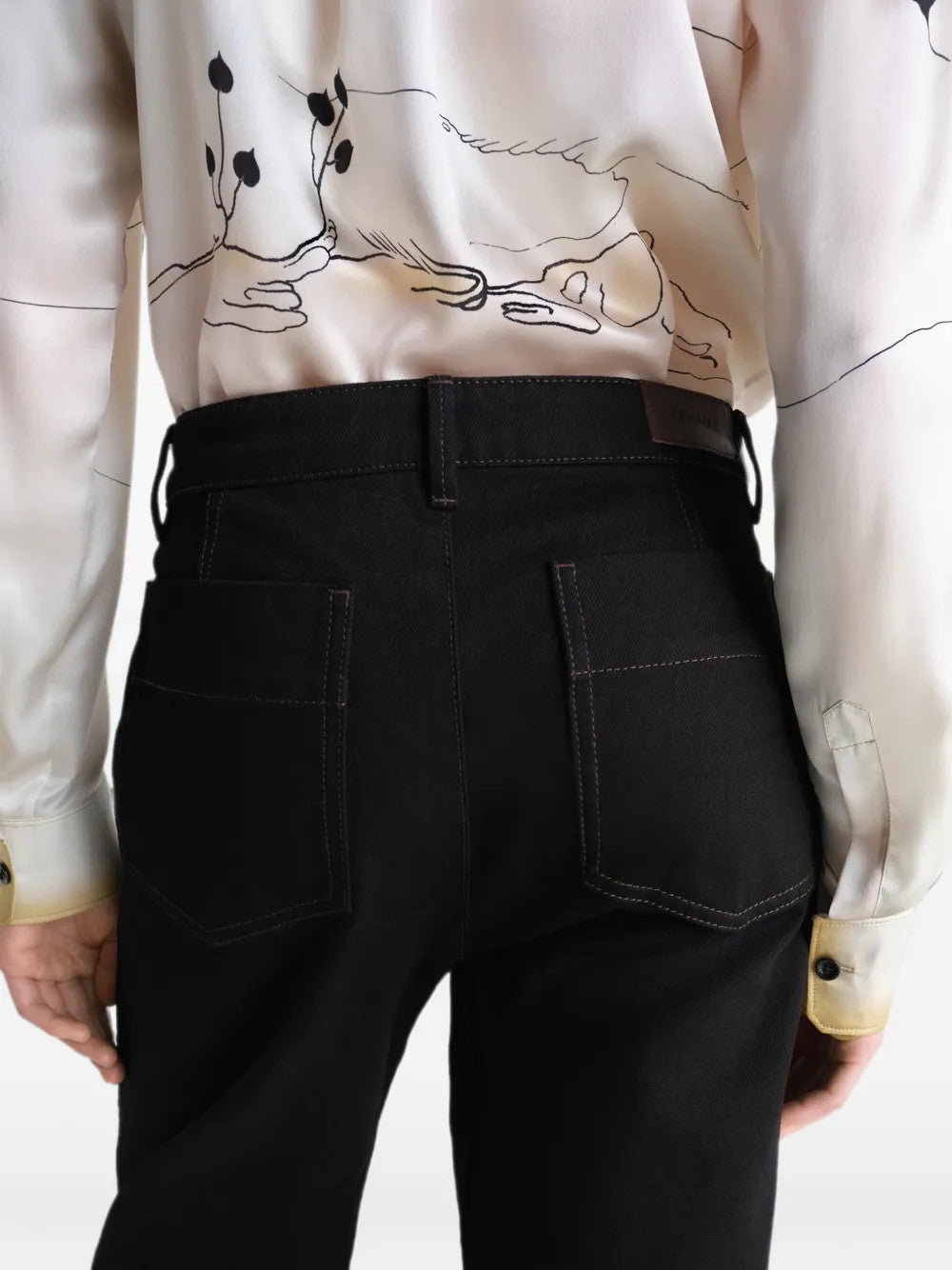 Black pants worn by a person, showing the pants fit
