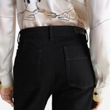 Black pants worn by a person, showing the pants fit