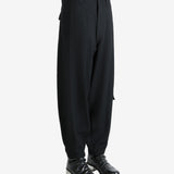 Black pants worn by a person, showing the pants's fit