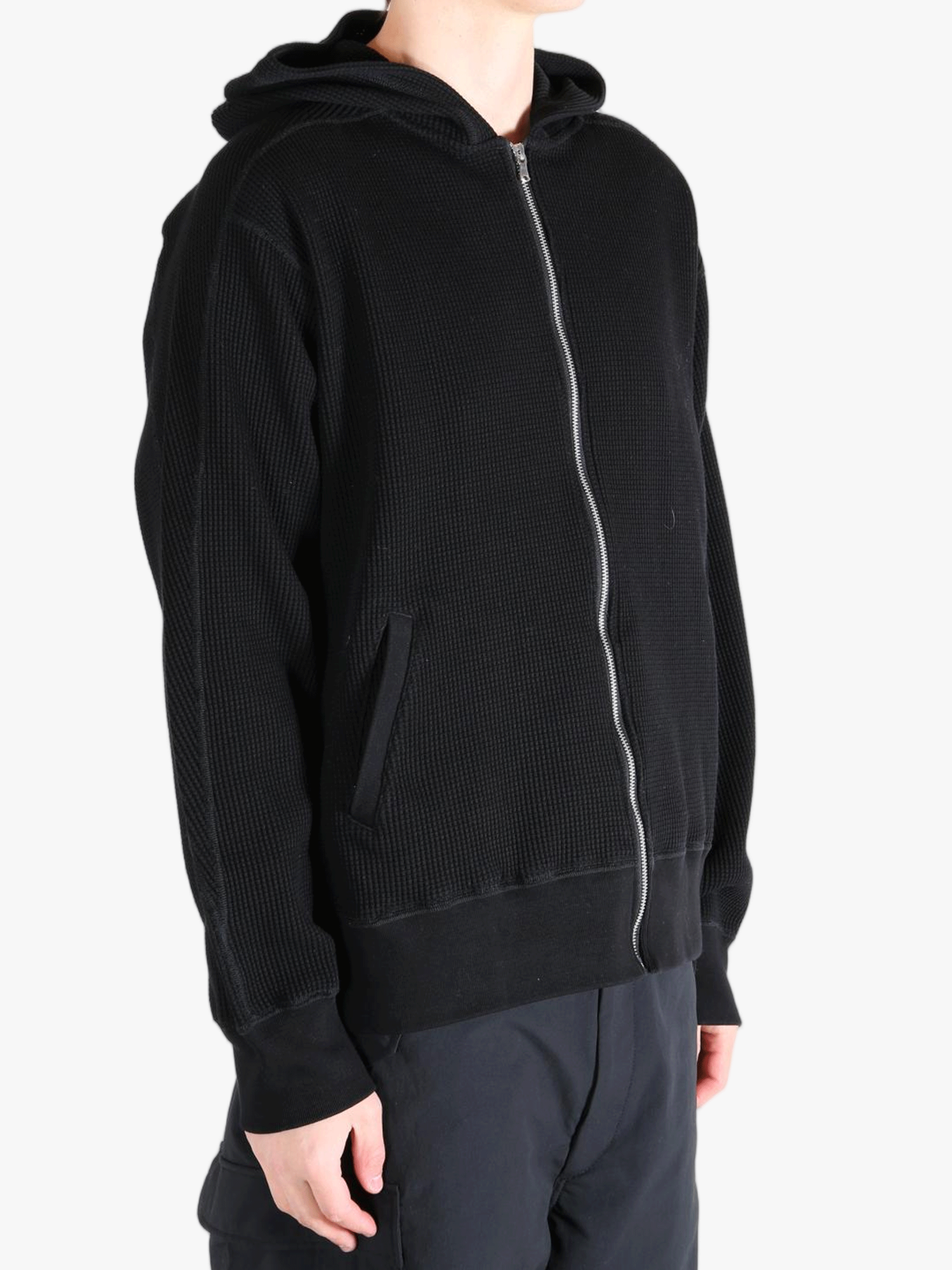 Black hoodie worn by a person, showing the hoodie's fit