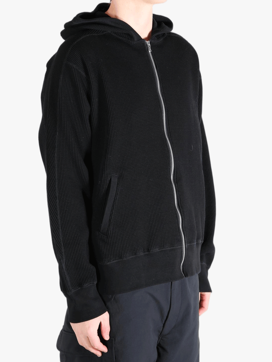 Black hoodie worn by a person, showing the hoodie's fit
