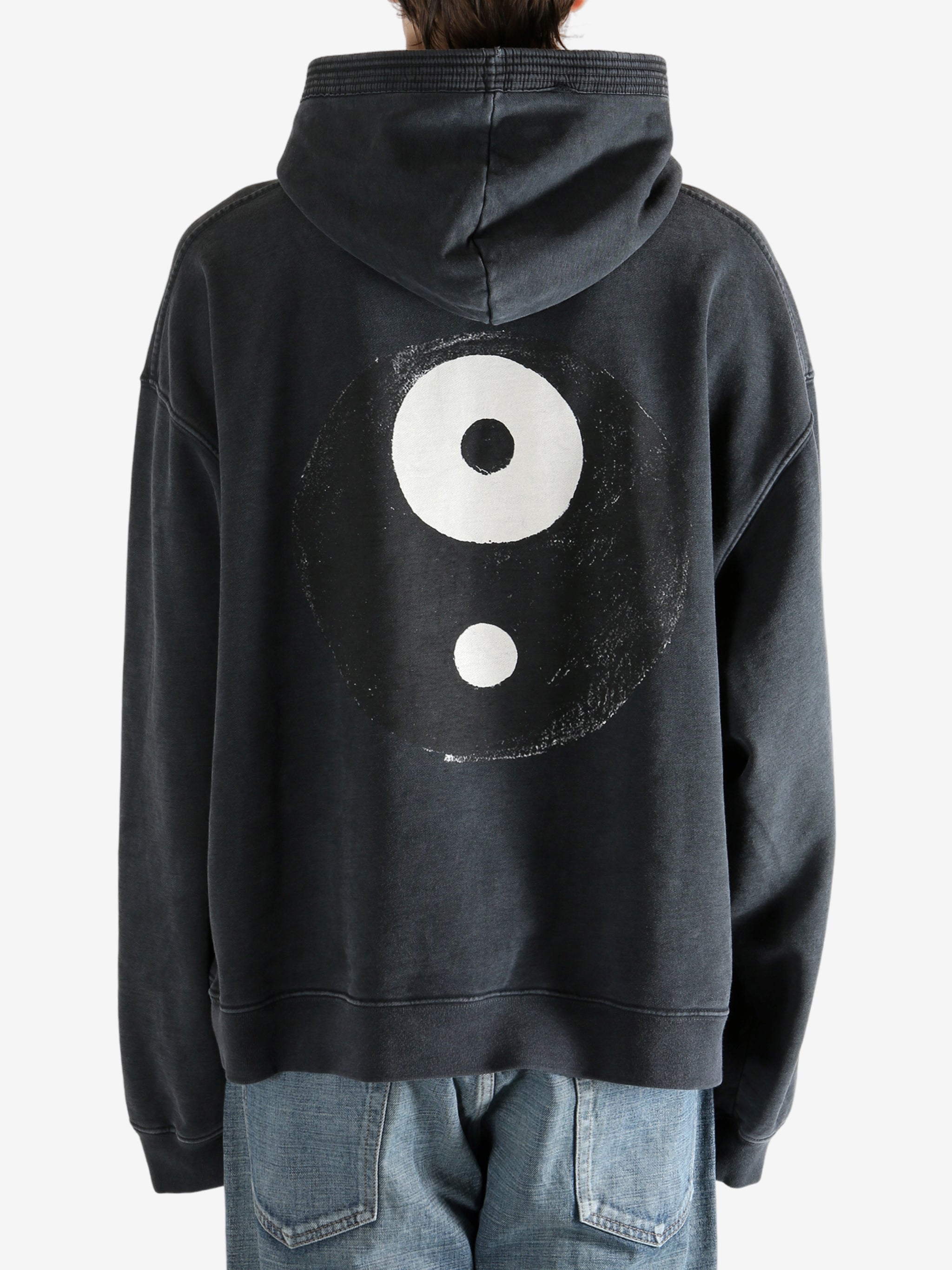 Black hoodie worn by a person, showing the hoodie's fit