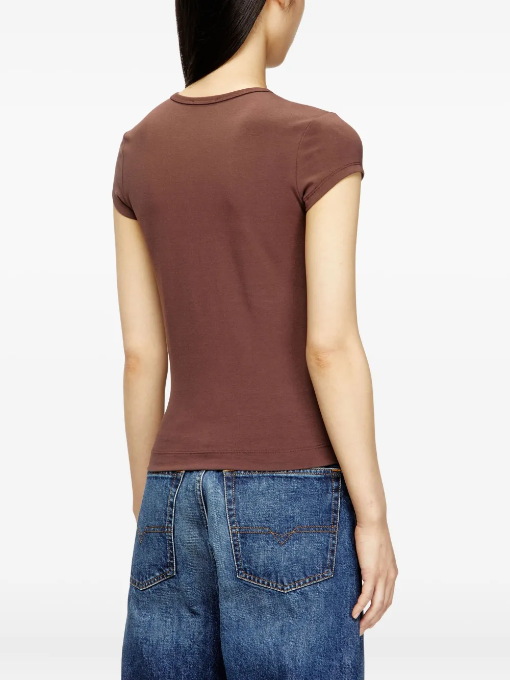 brown top worn by a person, showing the top fit