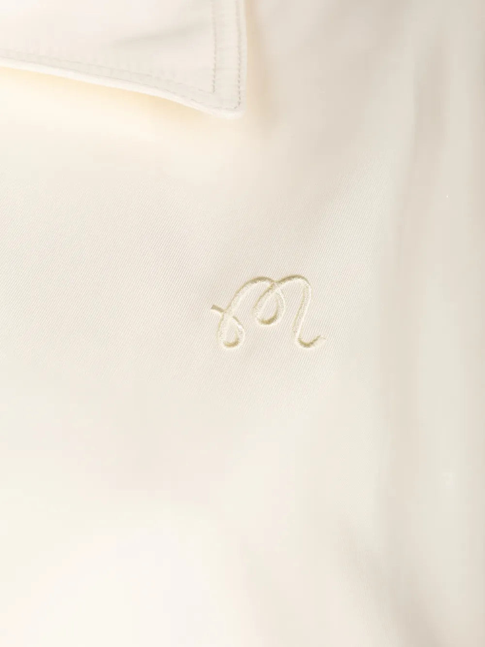 Close up of Tan jacket, showing texture of the 100% polyester fabric