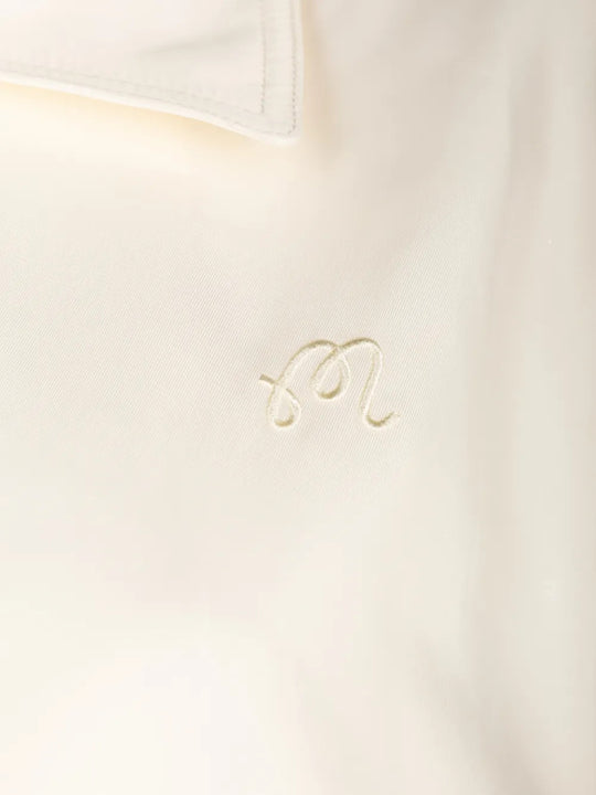 Close up of Tan jacket, showing texture of the 100% polyester fabric