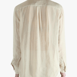 Tan shirt worn by a person, showing the shirt's fit