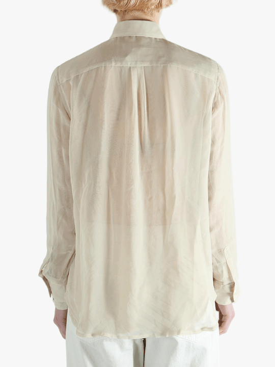 Tan shirt worn by a person, showing the shirt's fit