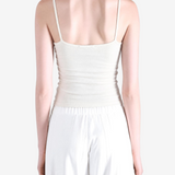 White top worn by a person, showing the top fit