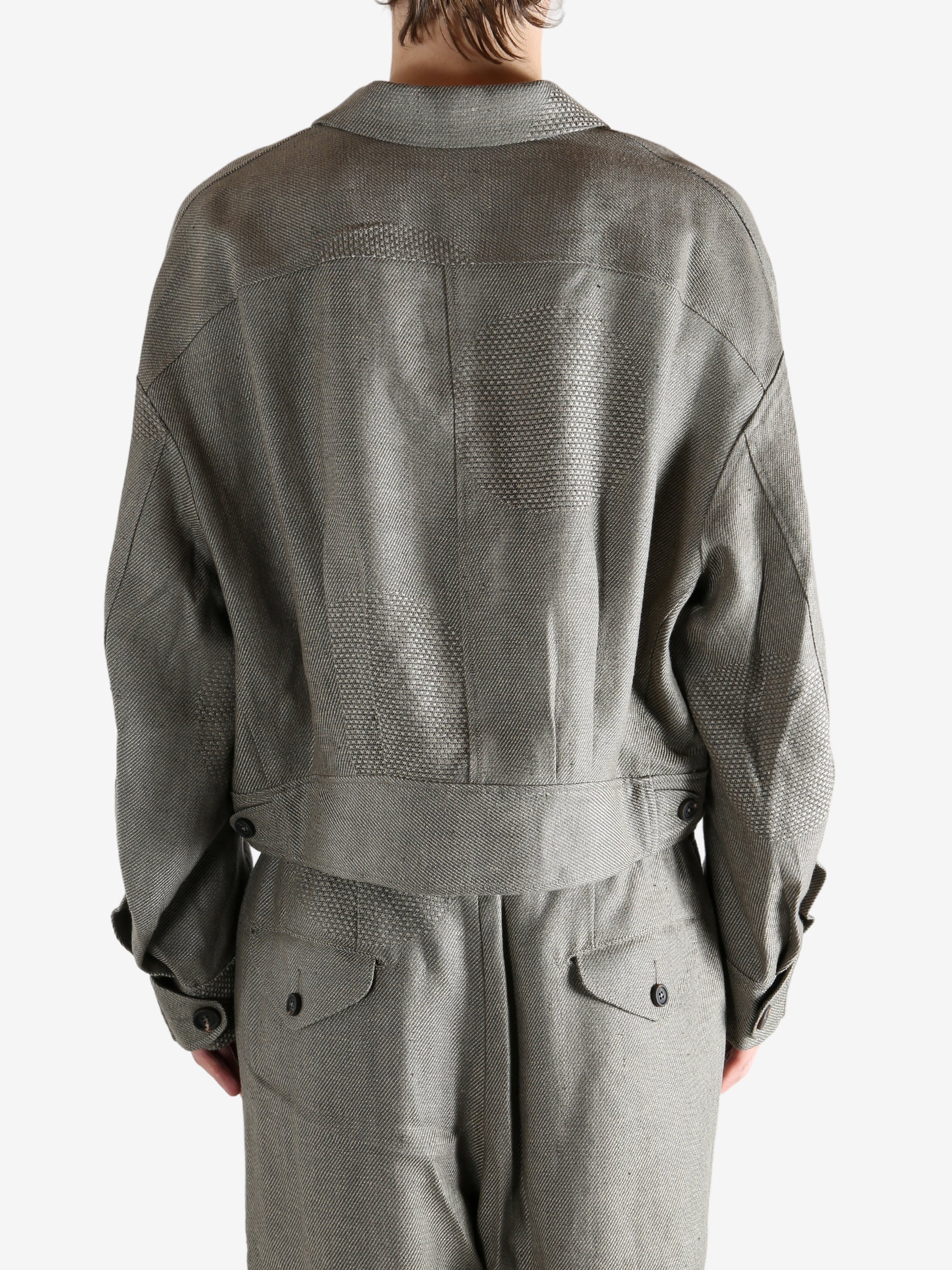 Grey jacket worn by a person, showing the jacket's fit