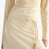 Tan dress worn by a person, showing the dress fit
