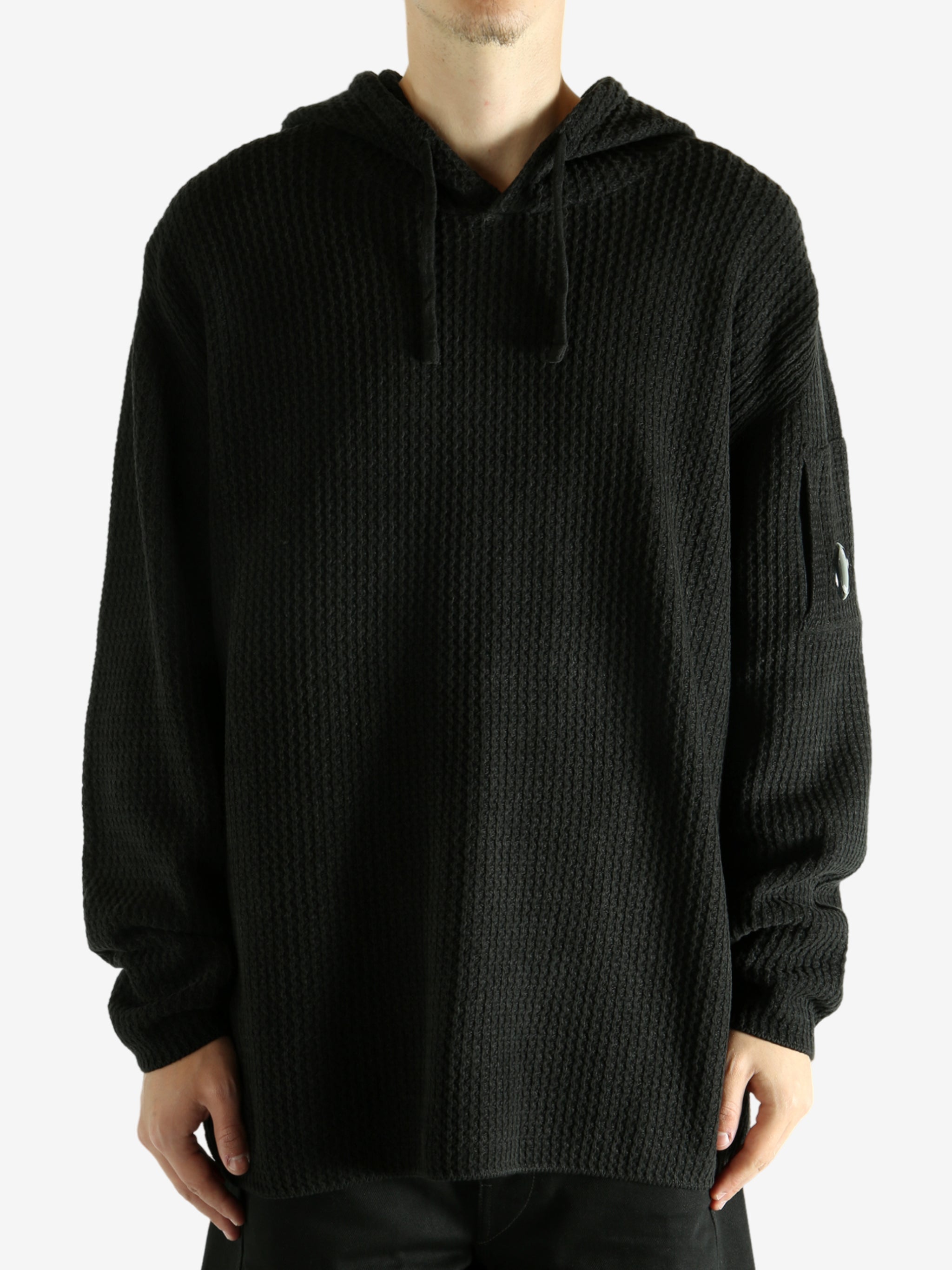 Black hoodie worn by a person, showing the hoodie's fit