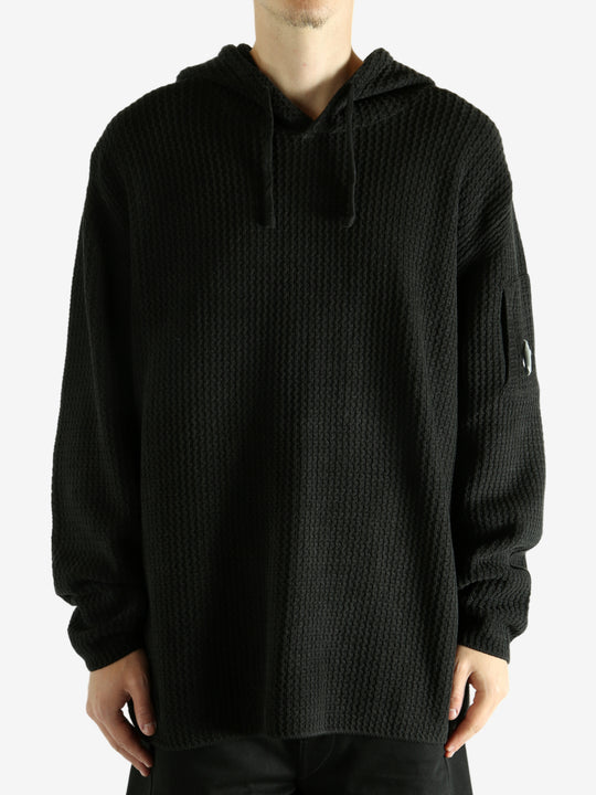 Black hoodie worn by a person, showing the hoodie's fit