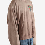 Brown hoodie worn by a person, showing the hoodie's fit