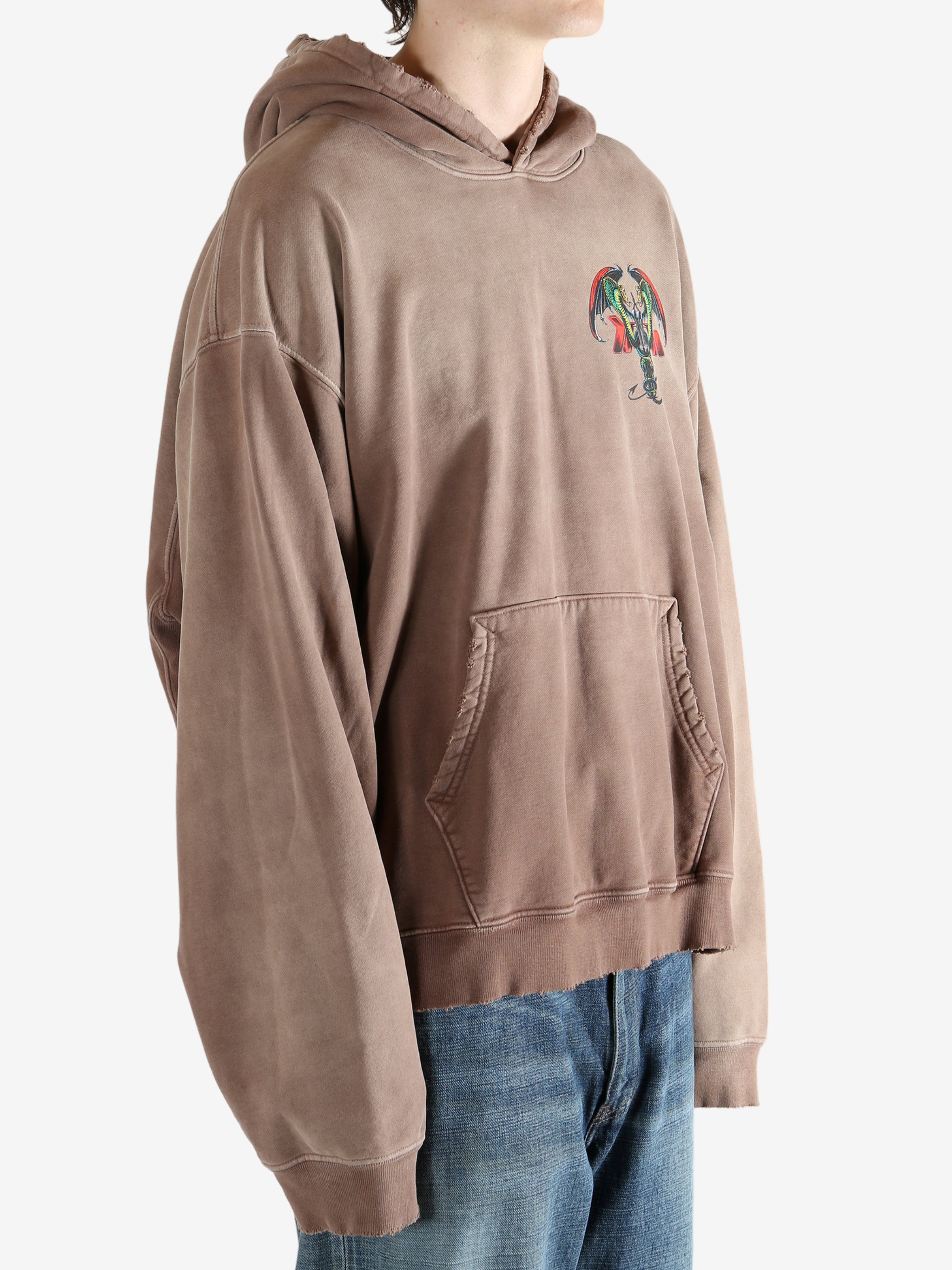 Brown hoodie worn by a person, showing the hoodie's fit