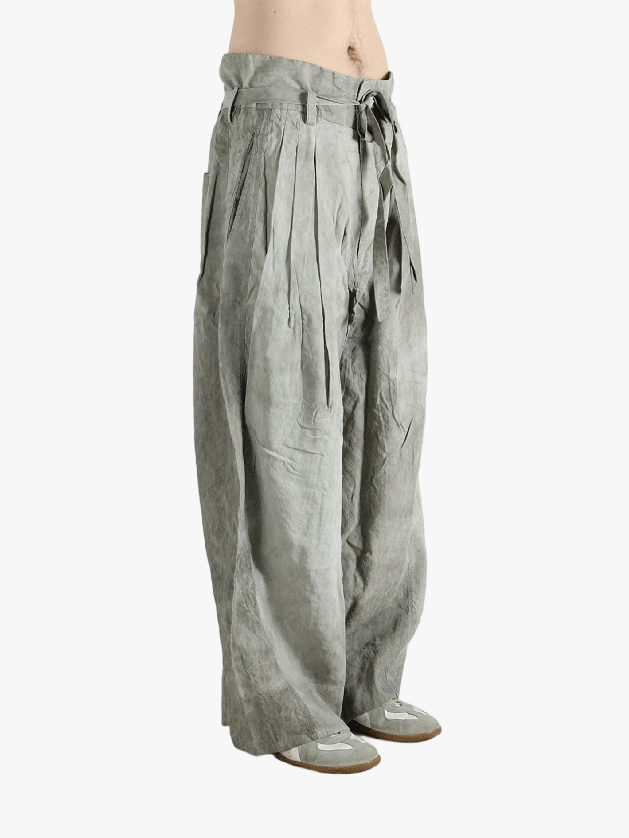 Gray wide-leg pants worn by a person, showing the pants fit