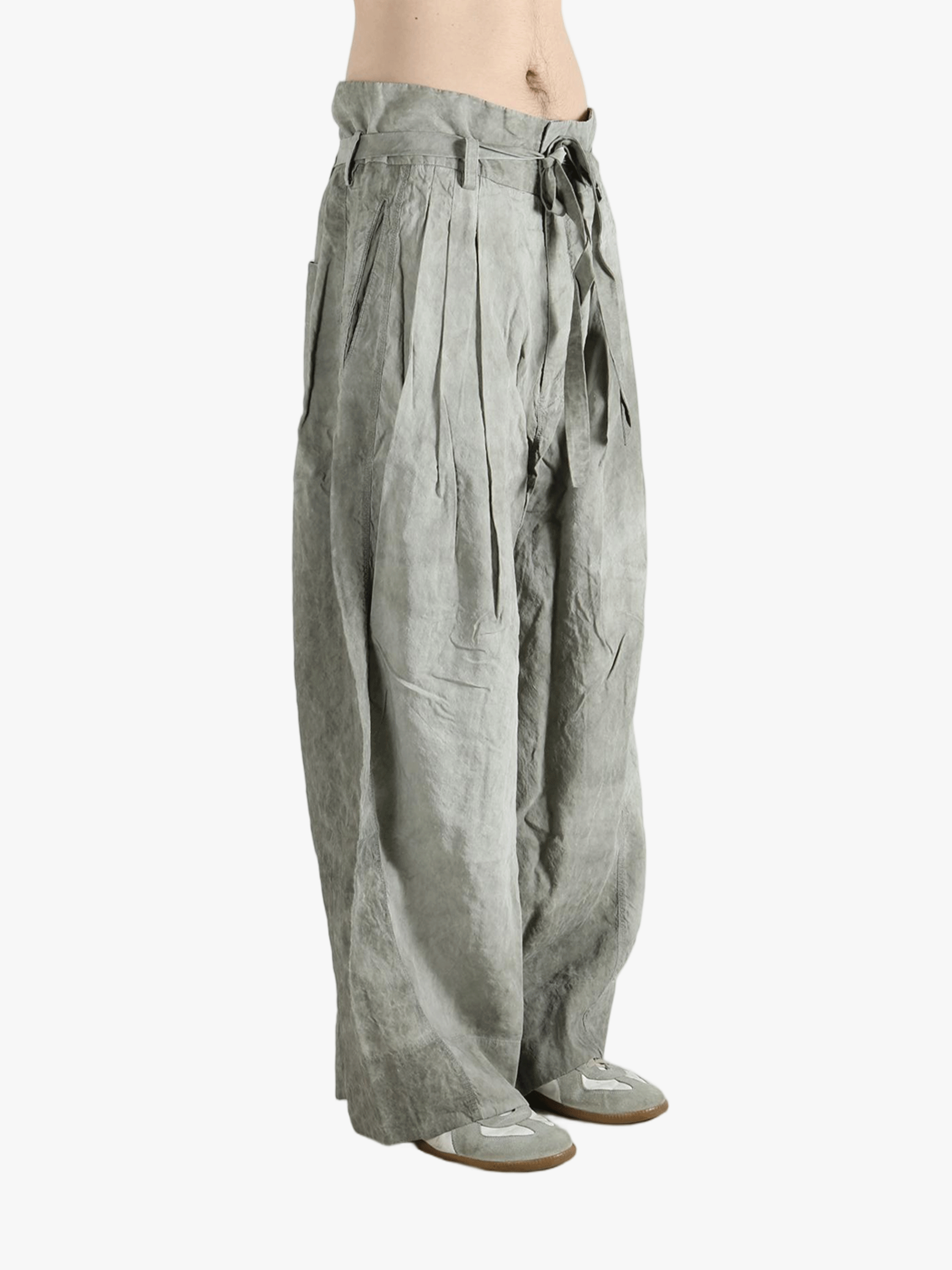 Gray wide-leg pants worn by a person, showing the pants fit