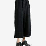 Black pants worn by a person, showing the pants fit