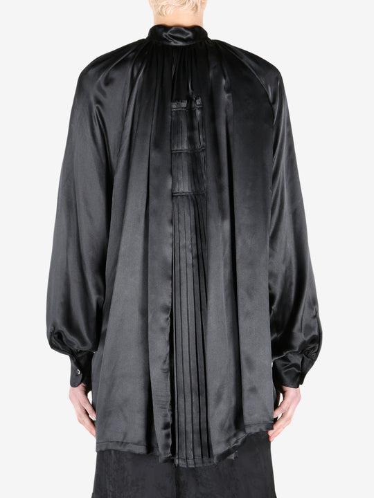 Black shirt worn by a person, showing the shirt fit