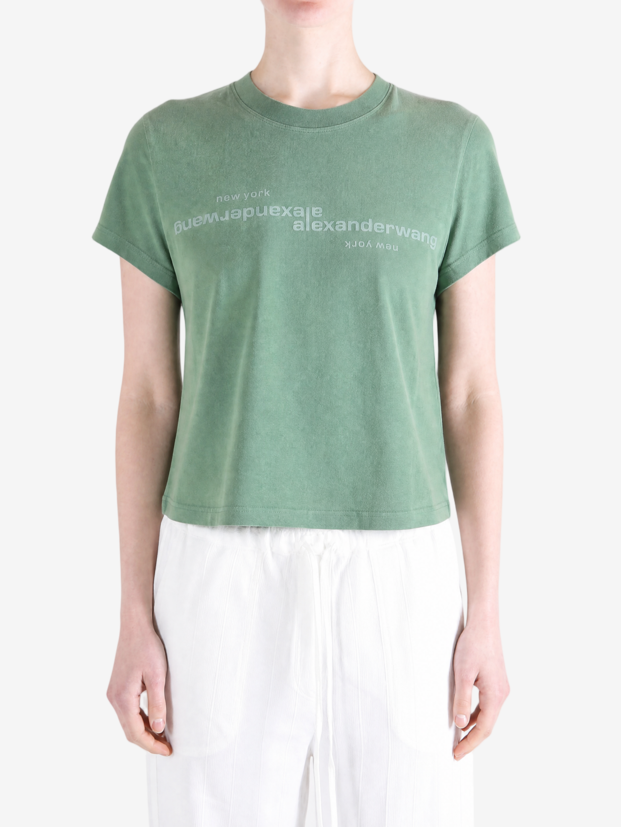 Green top worn by a person, showing the top fit