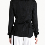 Black shirt worn by a person, showing the shirt fit