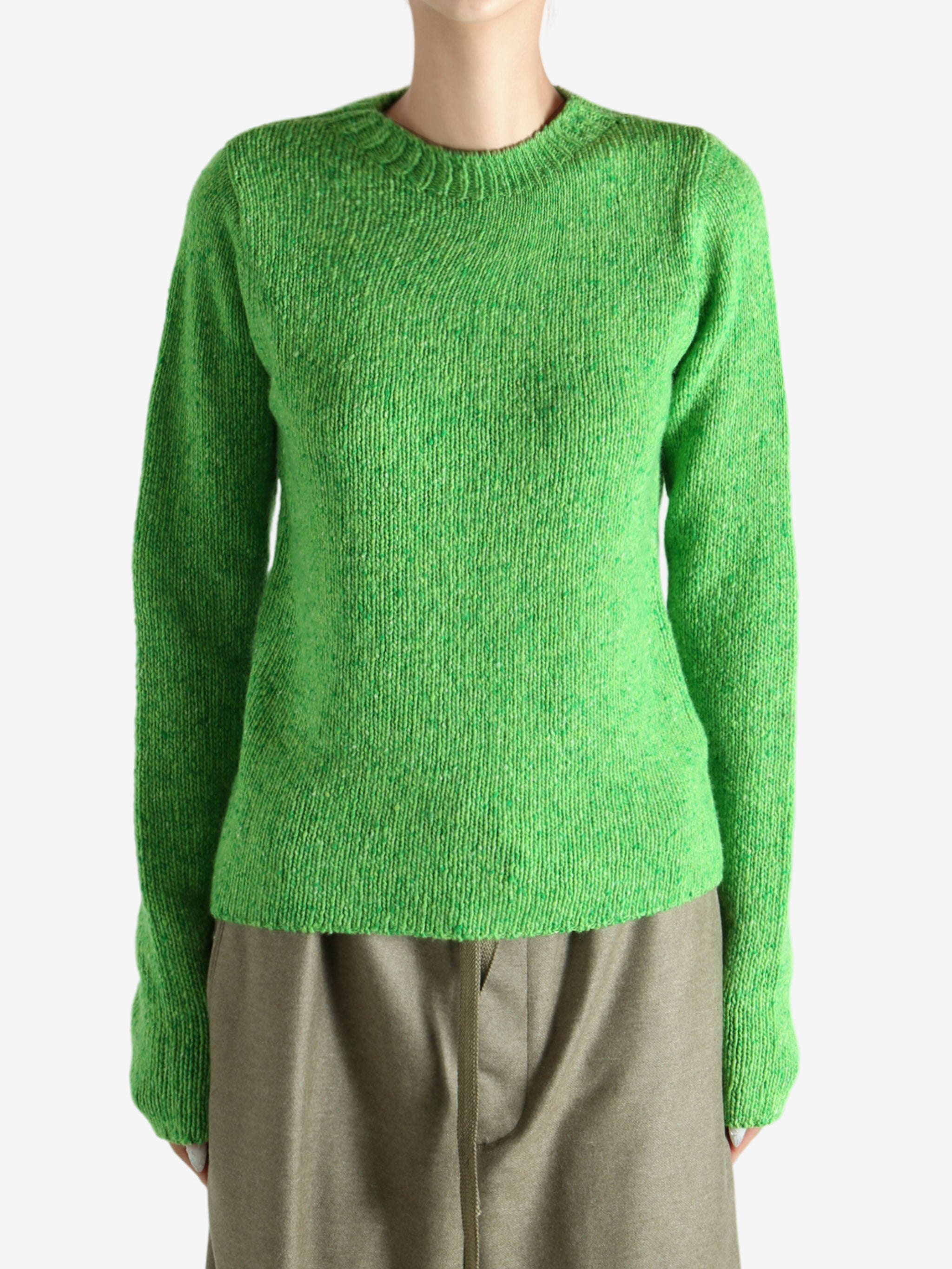 Green knitwear worn by a person, showing the knitwear fit