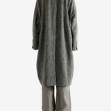 Grey coat worn by a person, showing the coat's fit