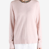 Pink knitwear worn by a person, showing the knitwear fit