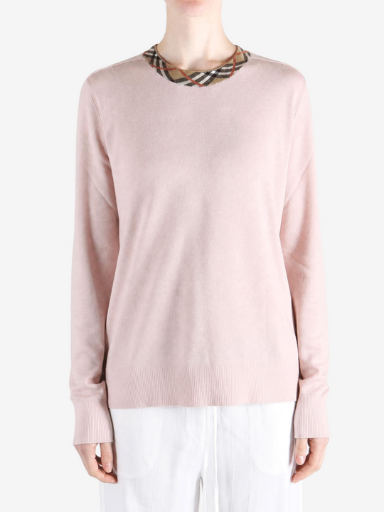 Pink knitwear worn by a person, showing the knitwear fit