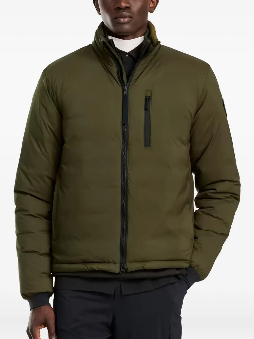 Green jacket worn by a person, showing the jacket fit