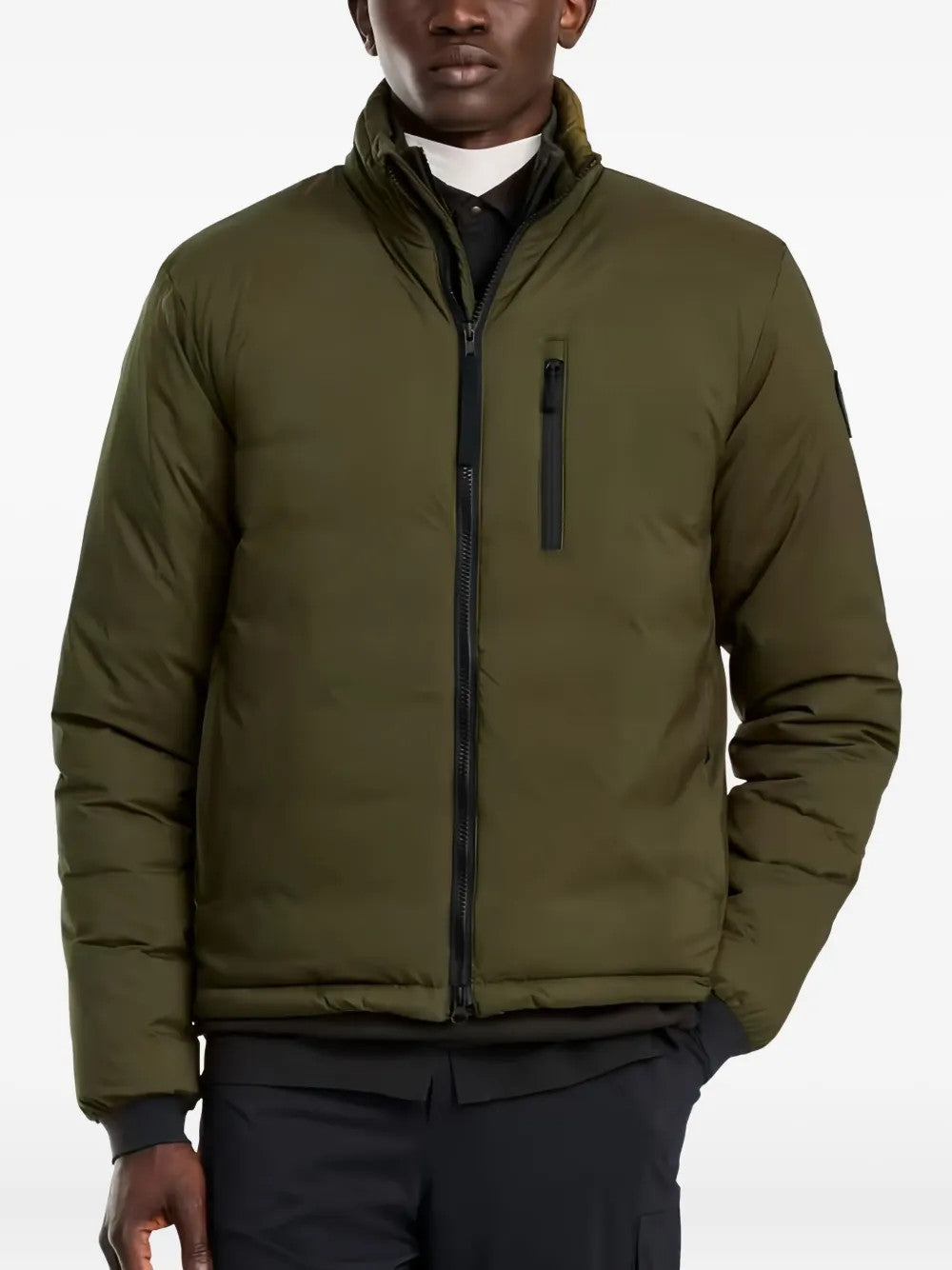 Green jacket worn by a person, showing the jacket fit