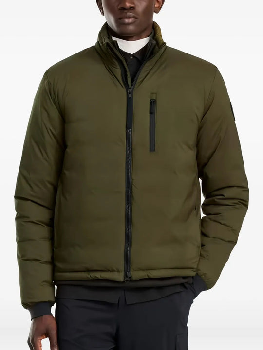 Green jacket worn by a person, showing the jacket fit