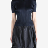 Navy top worn by a person, showing the top's fit