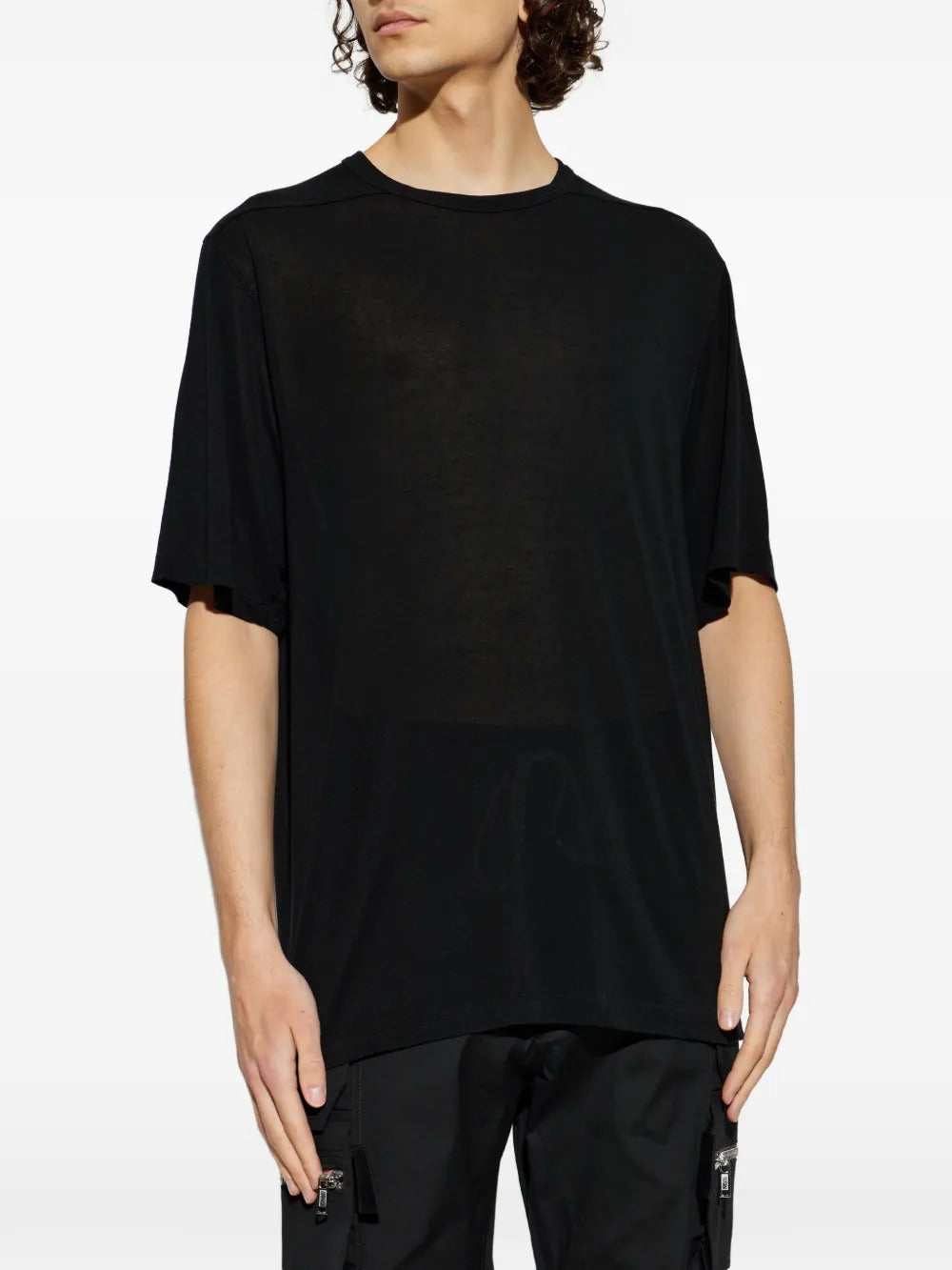 Black t-shirts worn by a person, showing the t-shirts fit