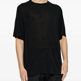 Black t-shirts worn by a person, showing the t-shirts fit