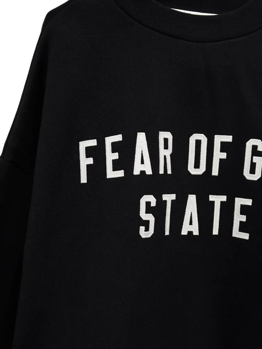 Close up of the black sweatshirt, showing texture of the cotton fabric