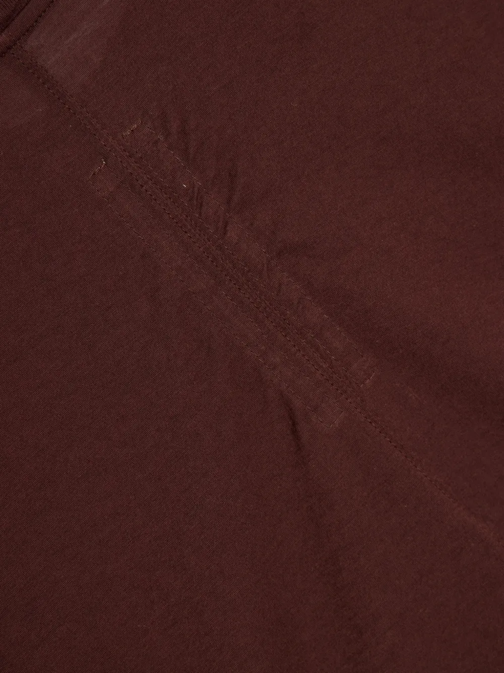 Close up of burgundy t-shirts , showing texture of the organic cotton fabric