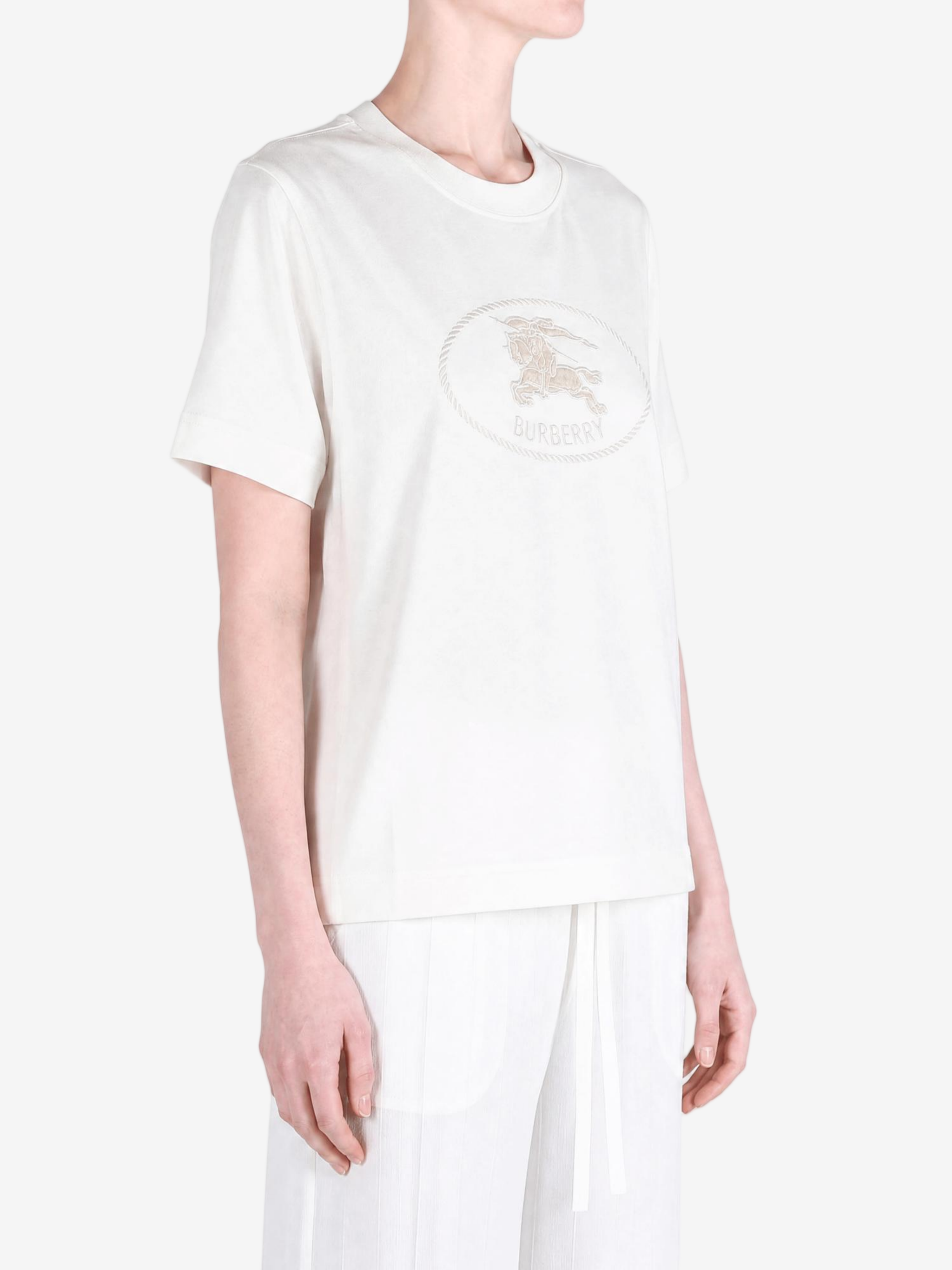 White top worn by a person, showing the top fit