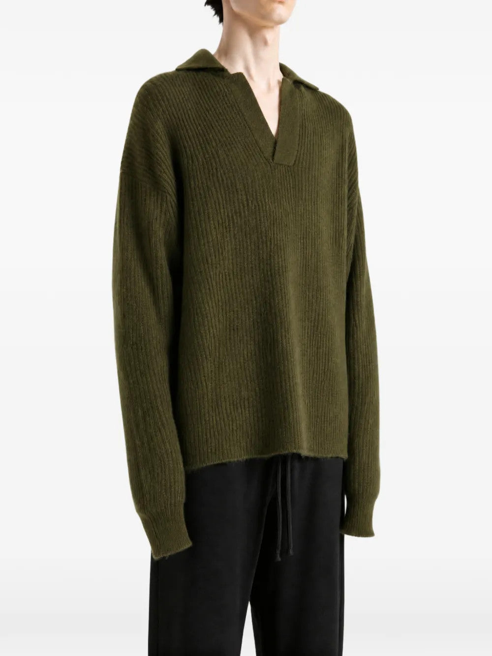 Green top worn by a person, showing the top fit