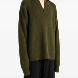 Green top worn by a person, showing the top fit