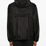 Black jackets-coats worn by a person, showing the  jackets-coats's fit