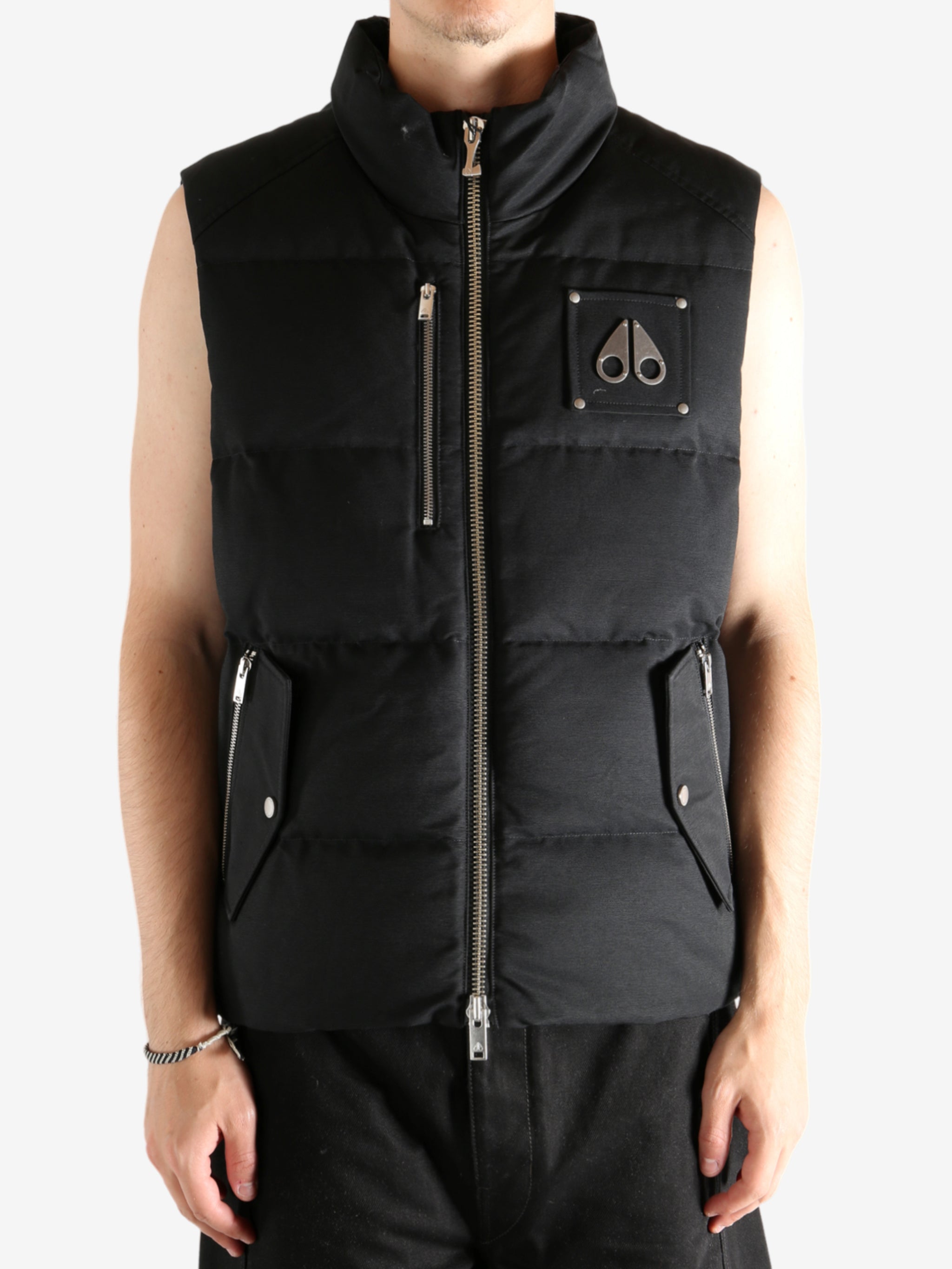 Black vest worn by a person, showing the vest's fit