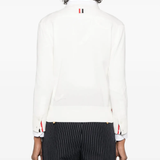 Whtie knitwear worn by a person, showing the cotton fit