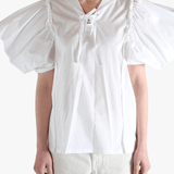 White top worn by a person, showing the top fit