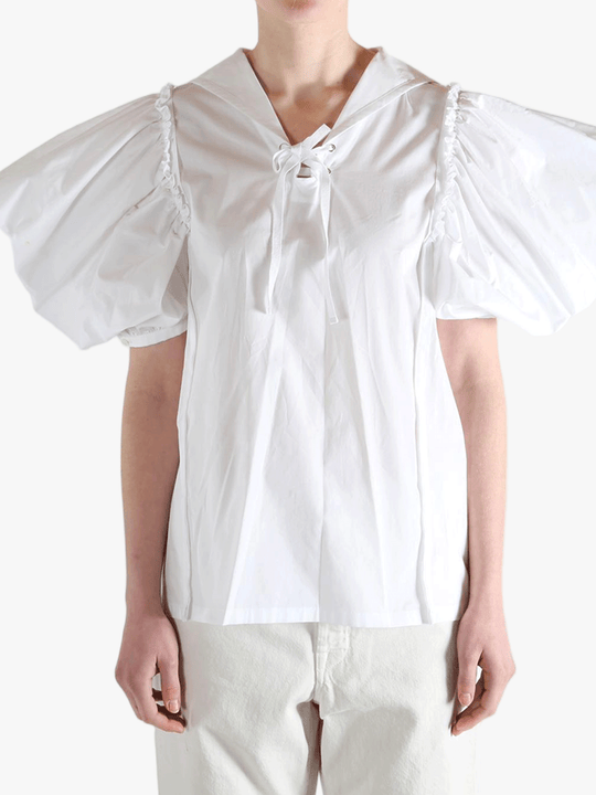 White top worn by a person, showing the top fit